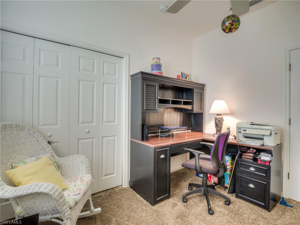 Office space with light colored carpet and ceiling fan