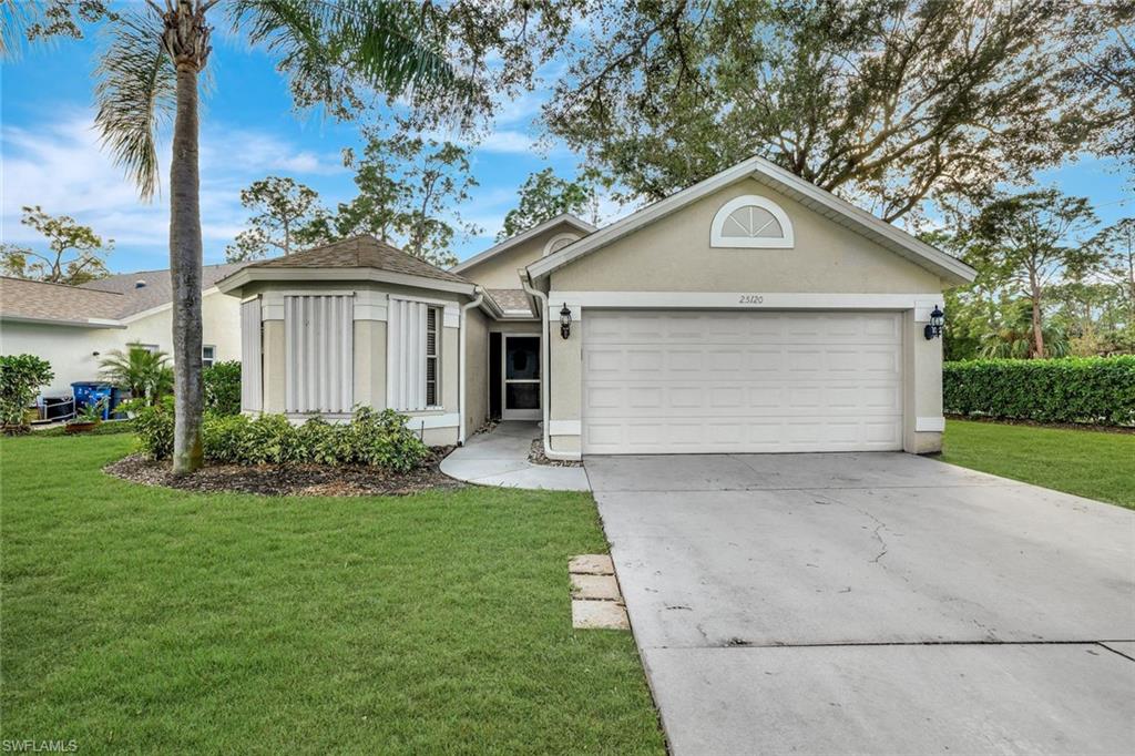 Ranch-style house with stucco siding, a front lawn, concrete driveway, and an attached garage