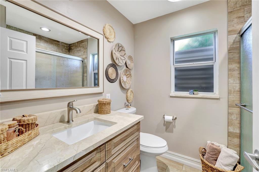 Bathroom with vanity and a shower with shower door