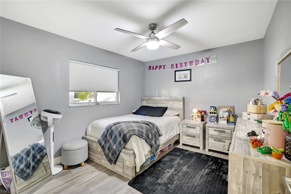 Bedroom featuring wood finished floors and a ceiling fan