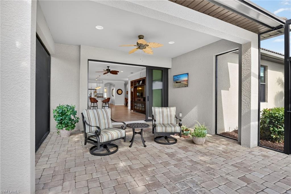 View of patio / terrace featuring ceiling fan and a sunroom