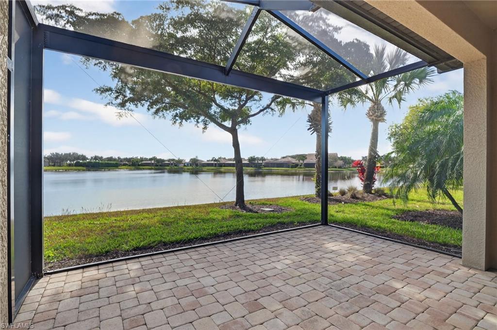 Unfurnished sunroom with a patio area and a water view