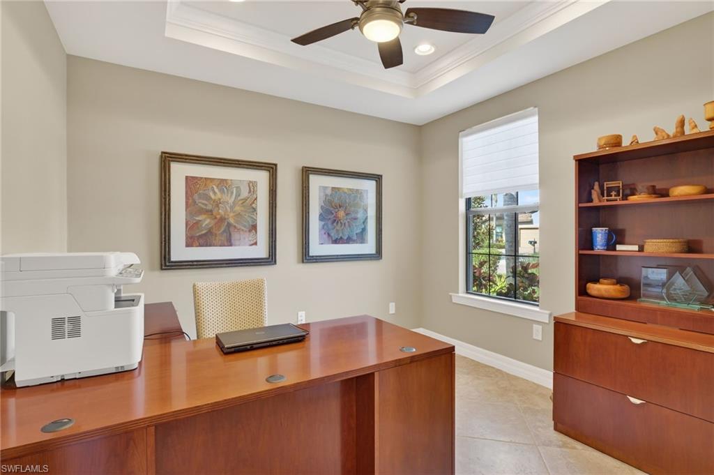 Office area with a raised ceiling, recessed lighting, light tile patterned floors, a ceiling fan, and crown molding