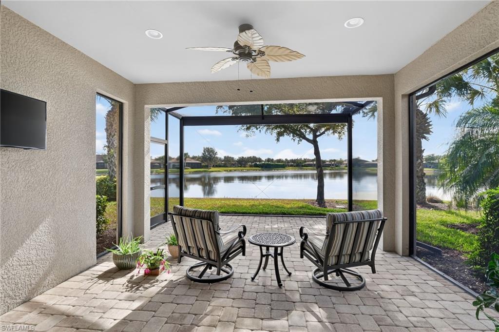 Sunroom featuring a water view