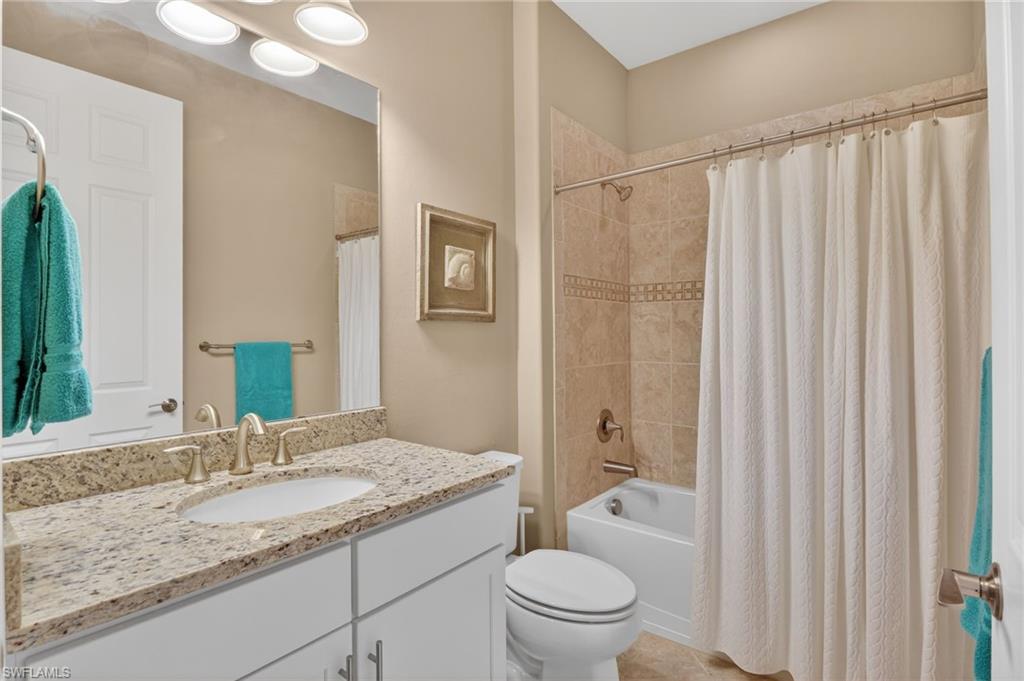 Bathroom with shower / tub combo and vanity