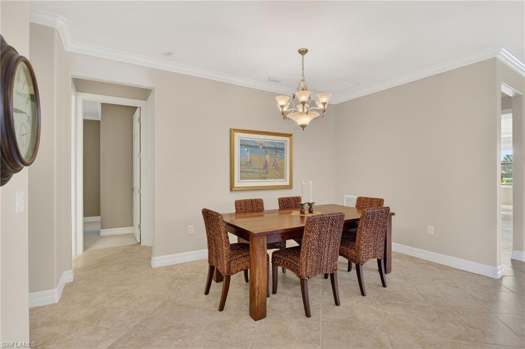 Dining area with a chandelier and ornamental molding