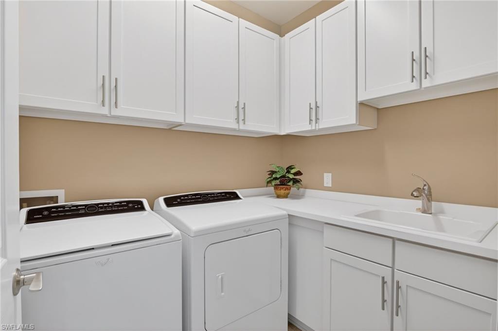 Laundry area with washer and clothes dryer and cabinet space