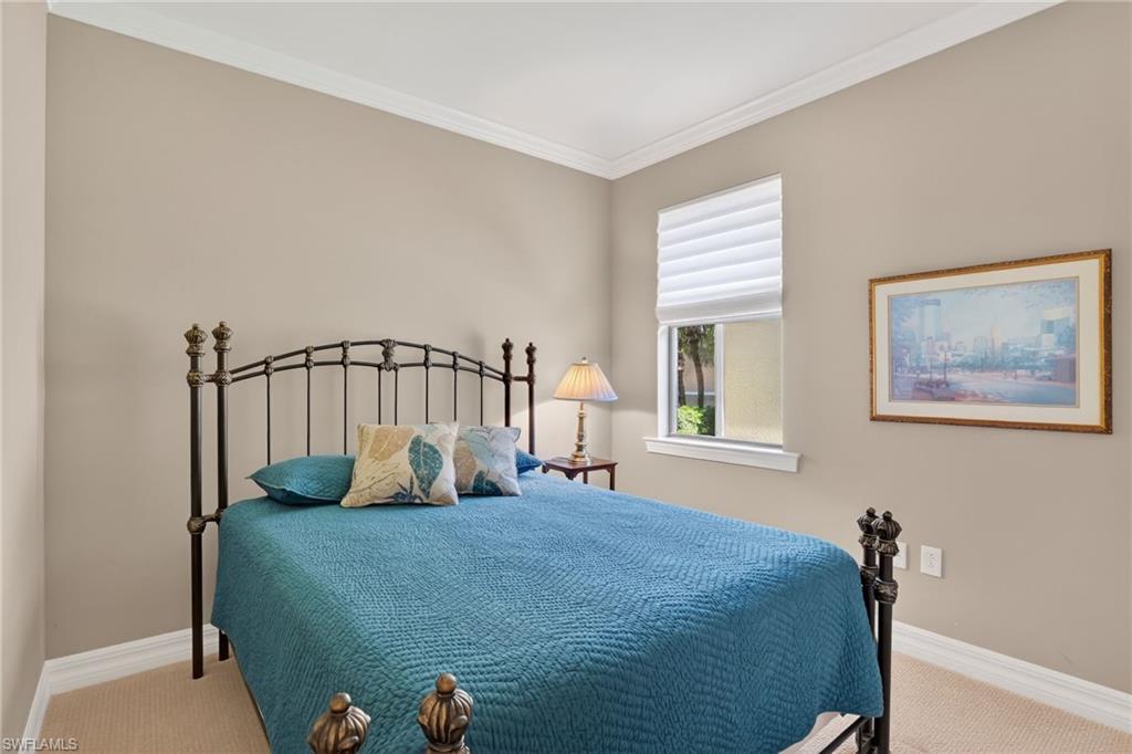 Bedroom with carpet floors and crown molding