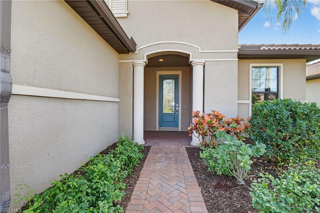 Doorway to property with stucco siding