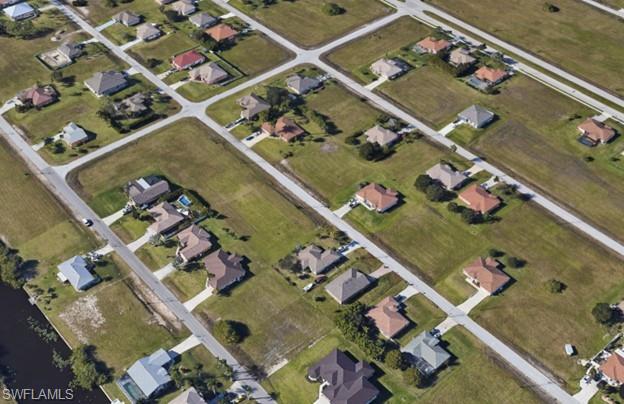 Aerial view of property's location featuring nearby suburban area