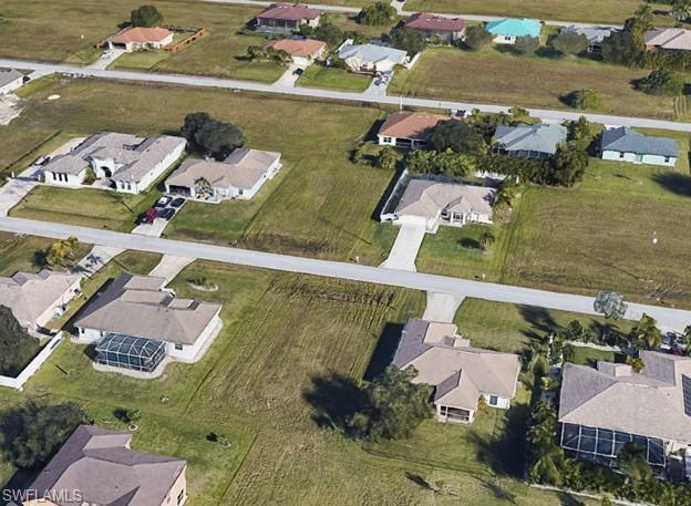 Aerial view of property's location featuring nearby suburban area