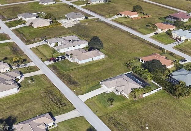 Aerial view of property's location featuring nearby suburban area
