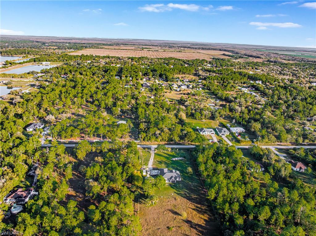 Aerial view of property and surrounding area featuring a nearby body of water