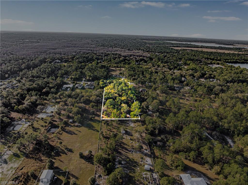Aerial view of property's location featuring property boundaries highlighted and a heavily wooded area