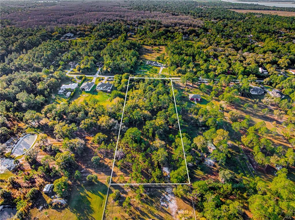 View of property location featuring property parcel outlined and a heavily wooded area