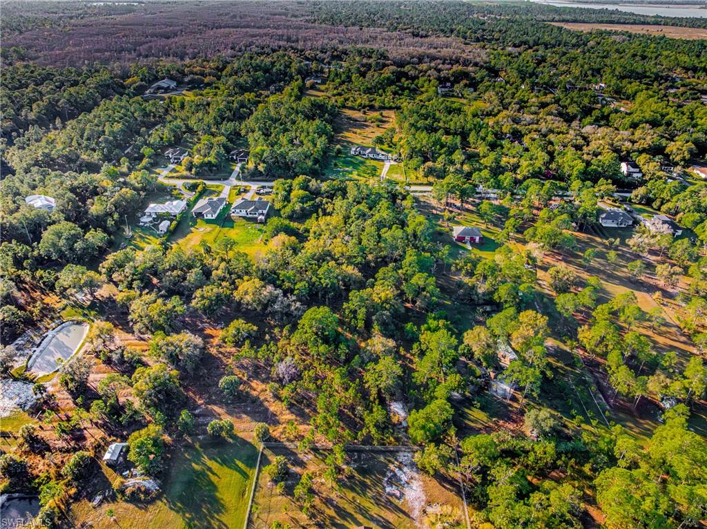 Aerial overview of property's location featuring a heavily wooded area