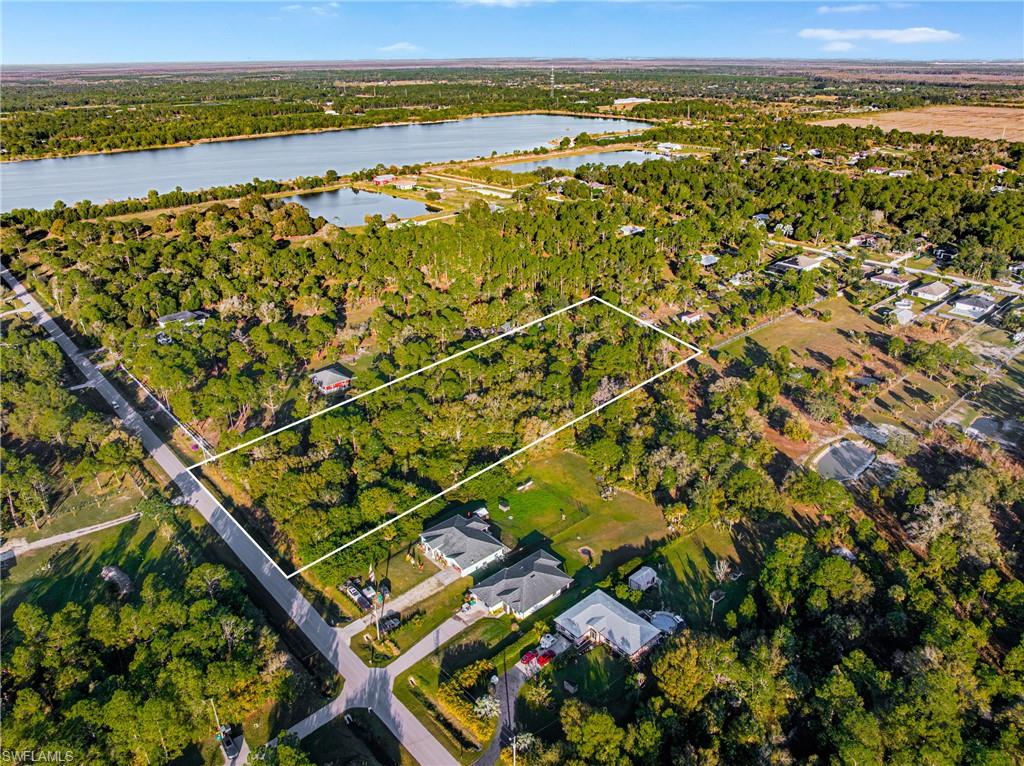Aerial view of property's location with property boundaries highlighted and a nearby body of water