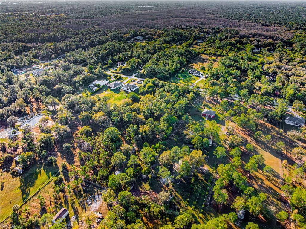 Aerial view of property's location with a heavily wooded area
