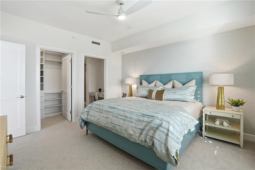 Carpeted bedroom with a spacious closet and ceiling fan - Virtually Edited Image