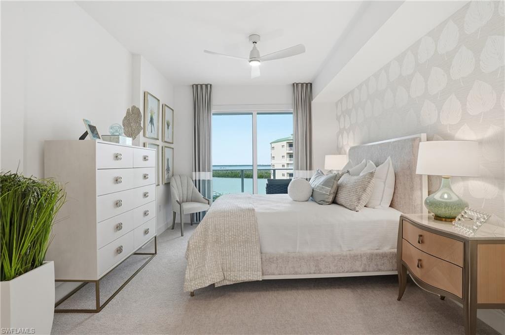 Bedroom featuring a water view, a ceiling fan, carpet, access to exterior, and wallpapered walls - Virtually Edited Image