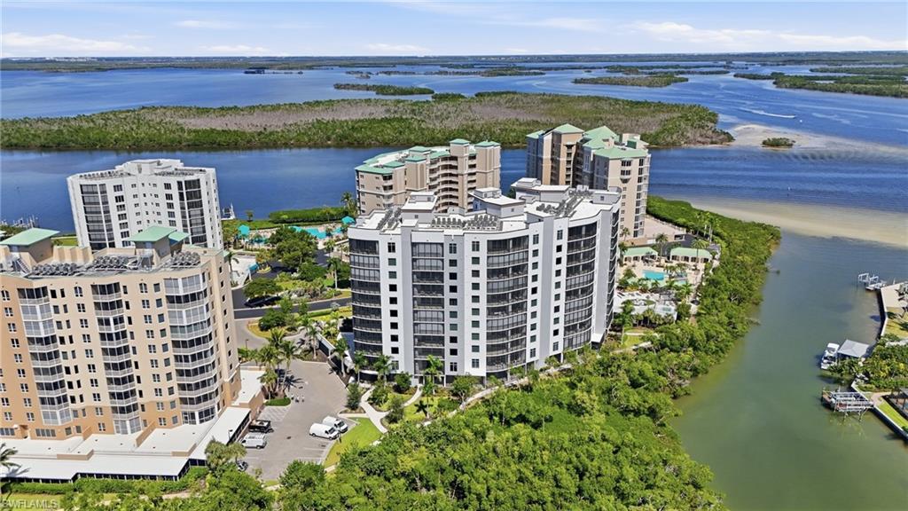 Bird's eye view of apartment complex and a large body of water - Virtually Edited Image