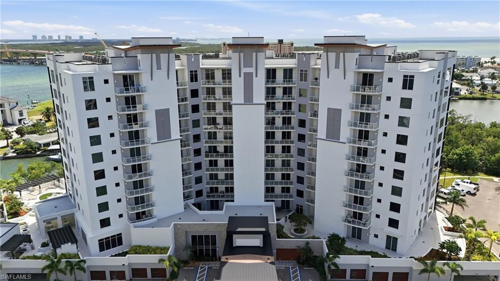 View of apartment building / complex featuring a water view - Virtually Edited Image