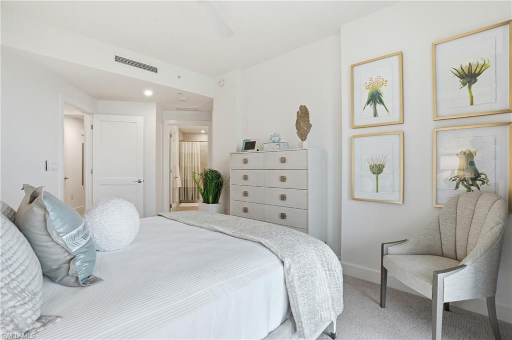Carpeted bedroom with a ceiling fan and recessed lighting - Virtually Edited Image