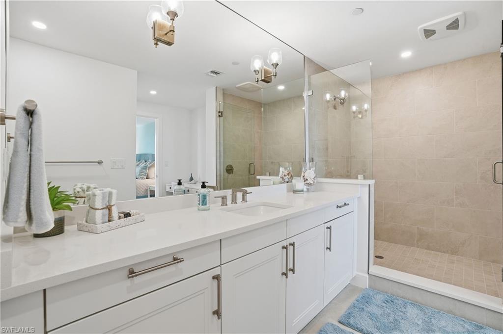 Ensuite bathroom with a stall shower, vanity, and recessed lighting - Virtually Edited Image