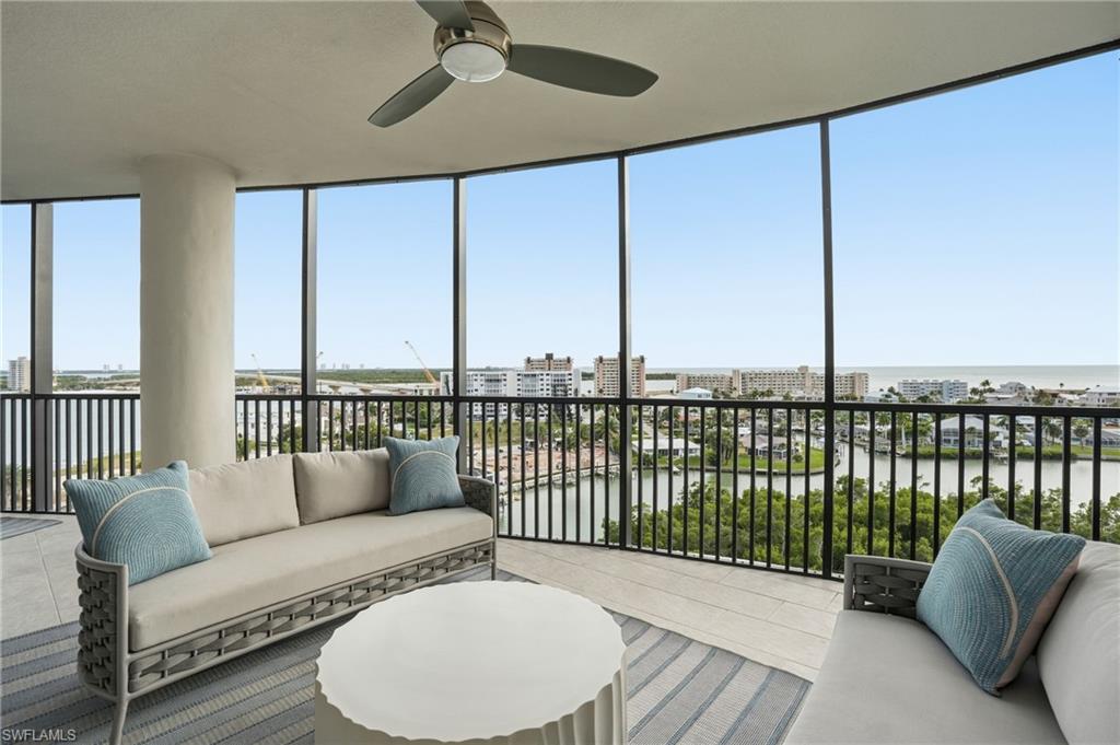 Sunroom featuring a water view and expansive windows - Virtually Edited Image