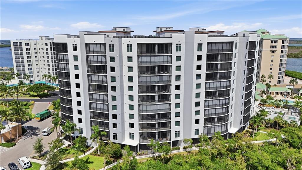 View of apartment building / complex featuring a water view - Virtually Edited Image
