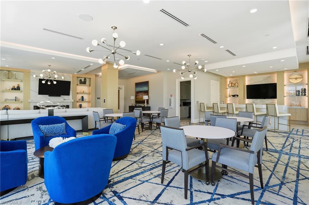 Dining area featuring a chandelier, recessed lighting, and built in shelves - Virtually Edited Image