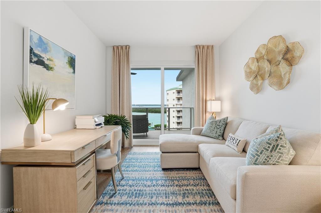 Home office with a water view and wood finished floors - Virtually Edited Image