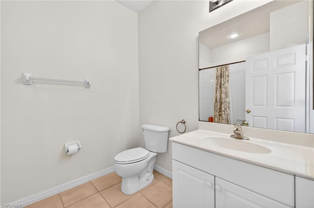 Bathroom featuring vanity, a shower with curtain, and light tile patterned flooring