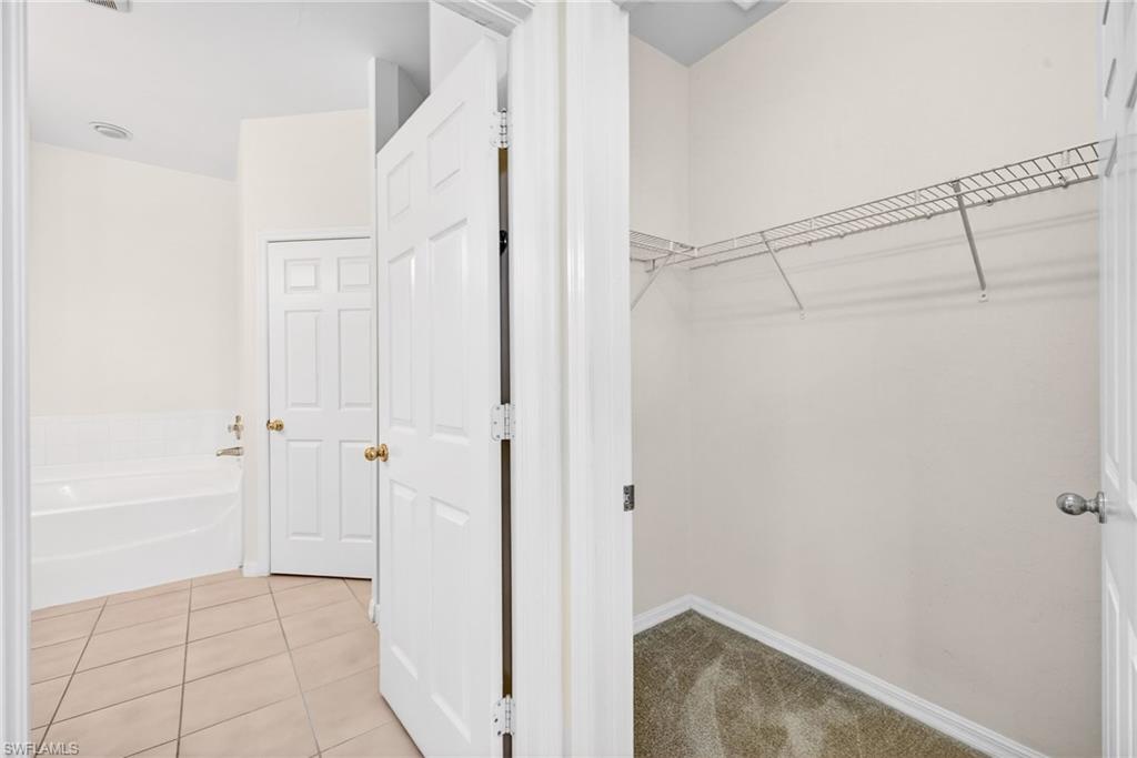 Spacious closet featuring light tile patterned floors