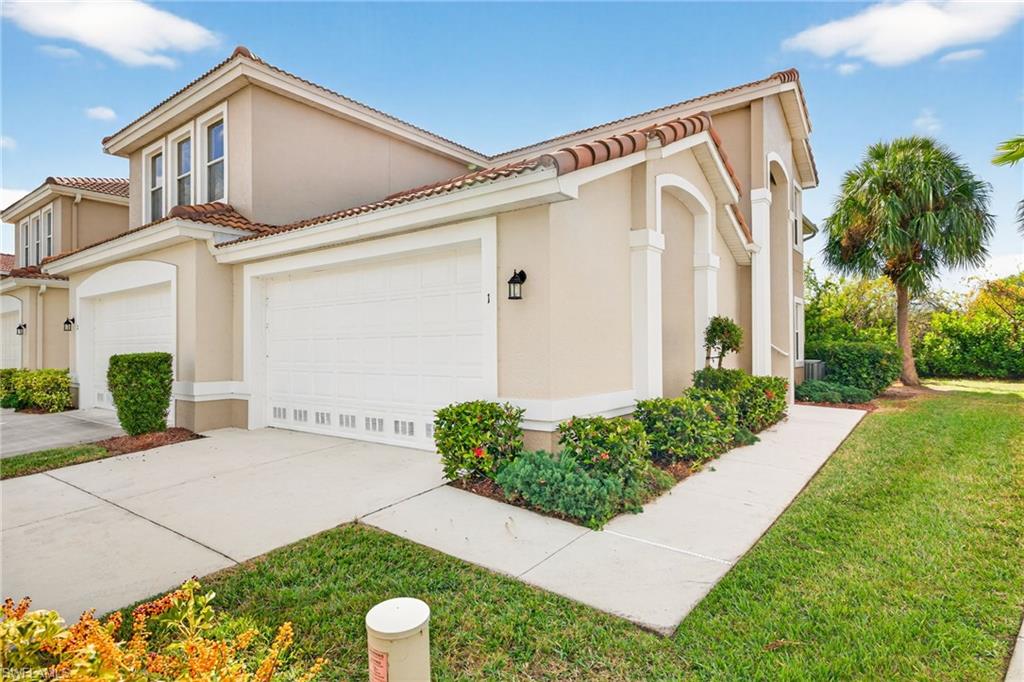 View of front of property featuring a front lawn, stucco siding, concrete driveway, and a tiled roof