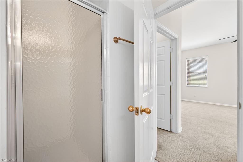 Full bathroom featuring carpet and a stall shower