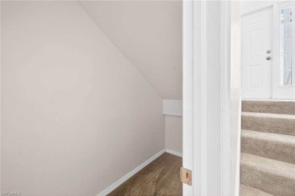 Stairway with carpet flooring and baseboards