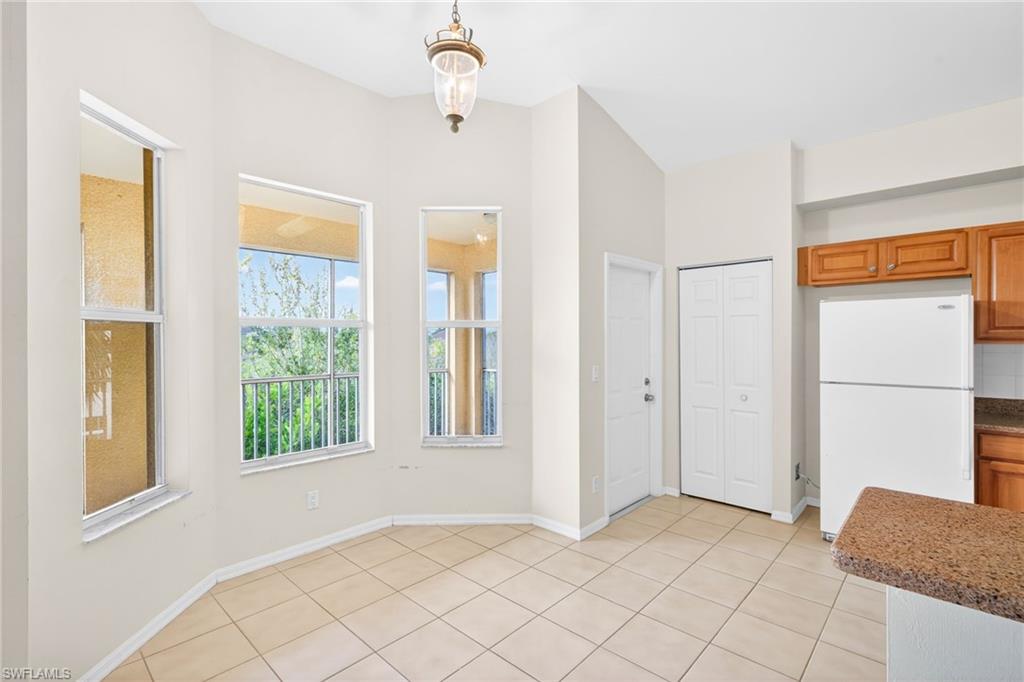 Unfurnished dining area with baseboards and light tile patterned floors