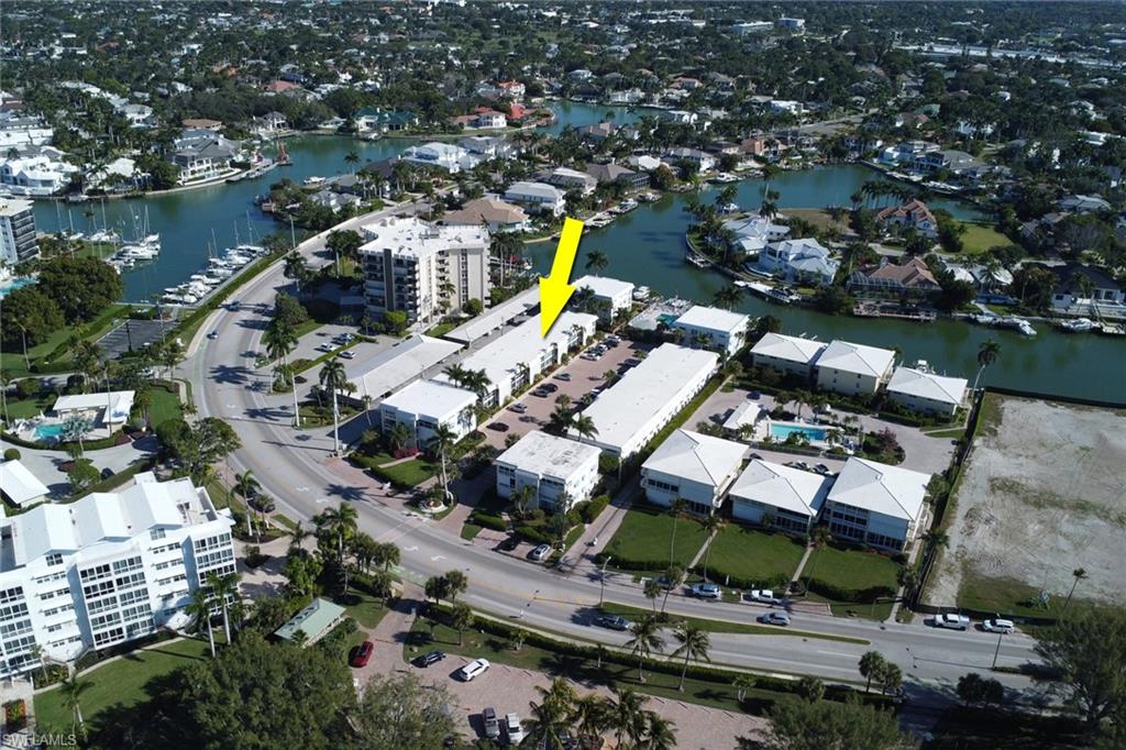 Aerial view of property's location with a large body of water