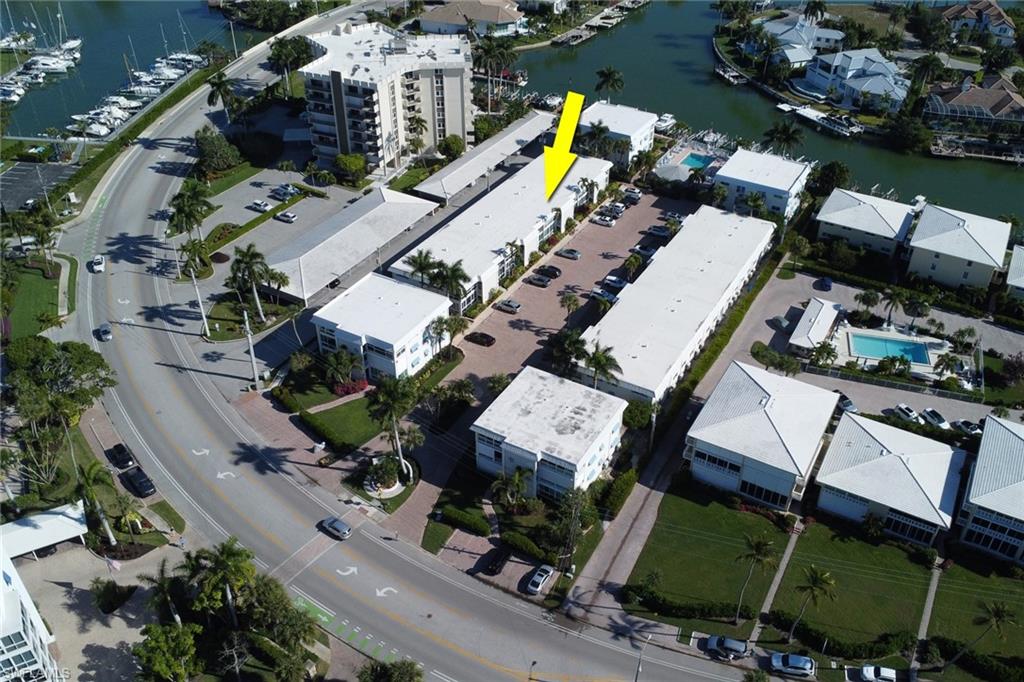 Aerial view of property's location with a large body of water