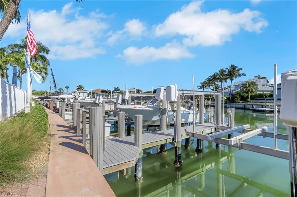 Dock area with boat lift and a water view