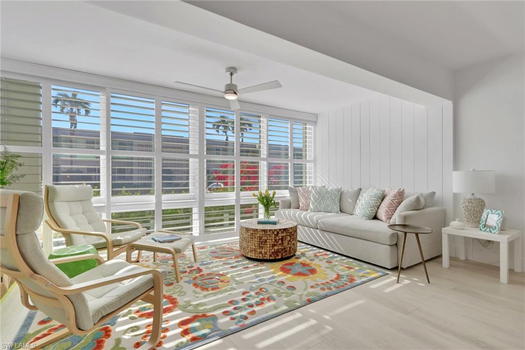 Living room featuring a ceiling fan and wood finished floors