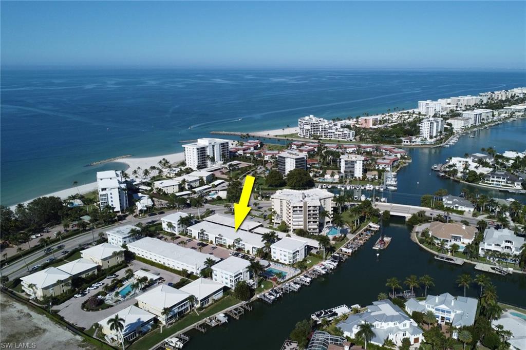 Aerial view of property's location with a nearby body of water and nearby urban area