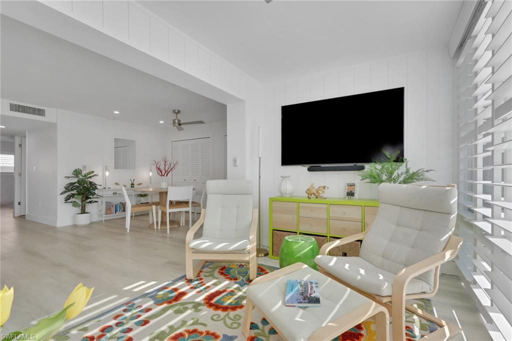 Recreation room featuring wood finished floors, a ceiling fan, and recessed lighting