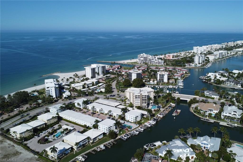 Aerial view of property and surrounding area with a large body of water and nearby urban area
