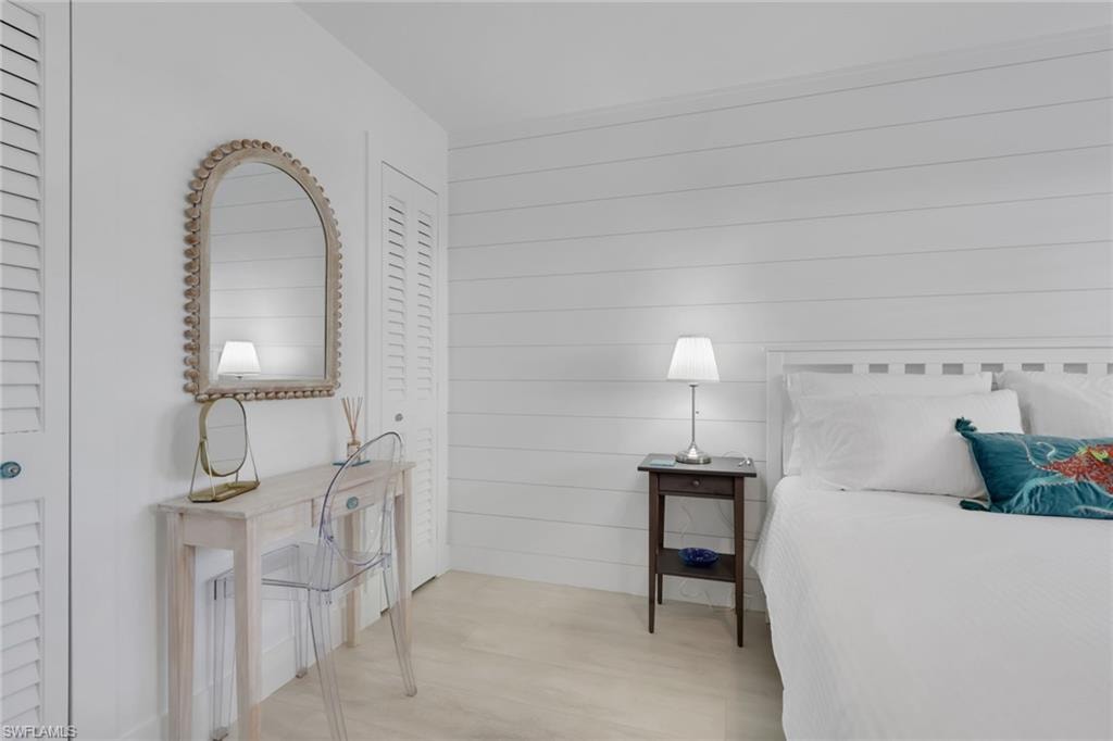 Bedroom with wooden walls and wood finished floors