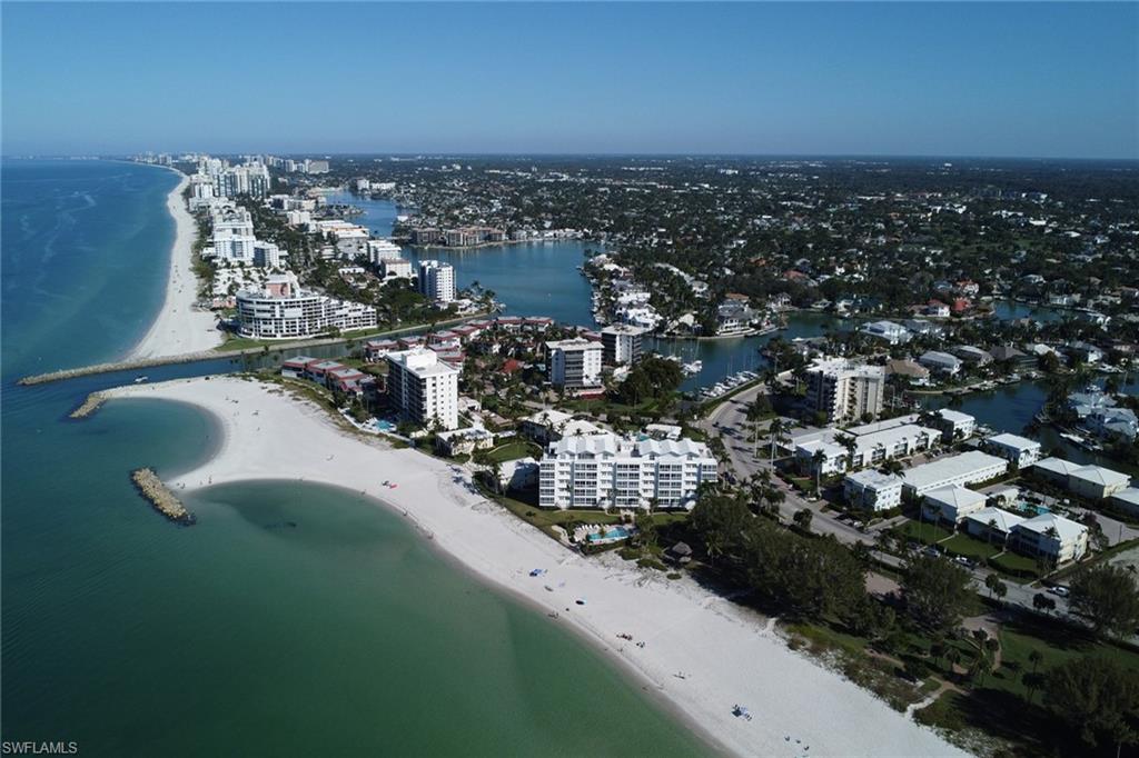 View of property location featuring unending shoreline and nearby urban area
