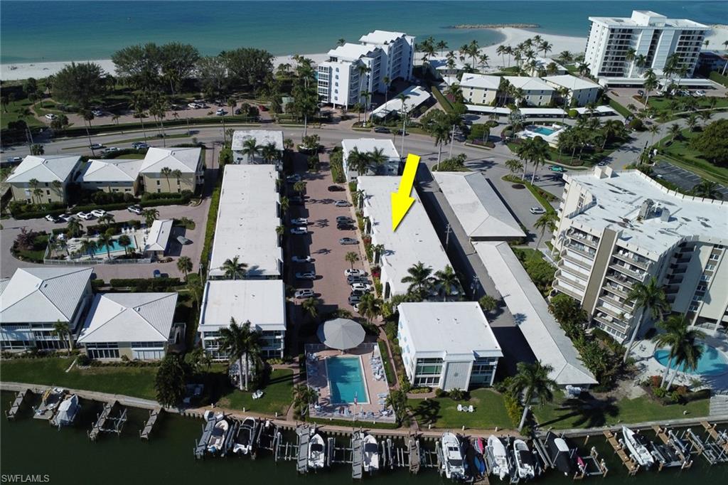 View of property location with a nearby body of water and a marina