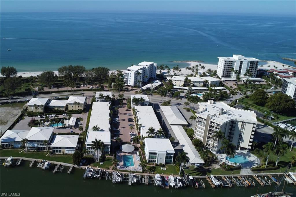 Aerial view of property and surrounding area featuring a nearby body of water