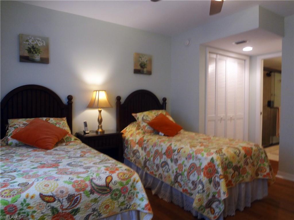 Bedroom featuring a closet, wood finished floors, and ceiling fan